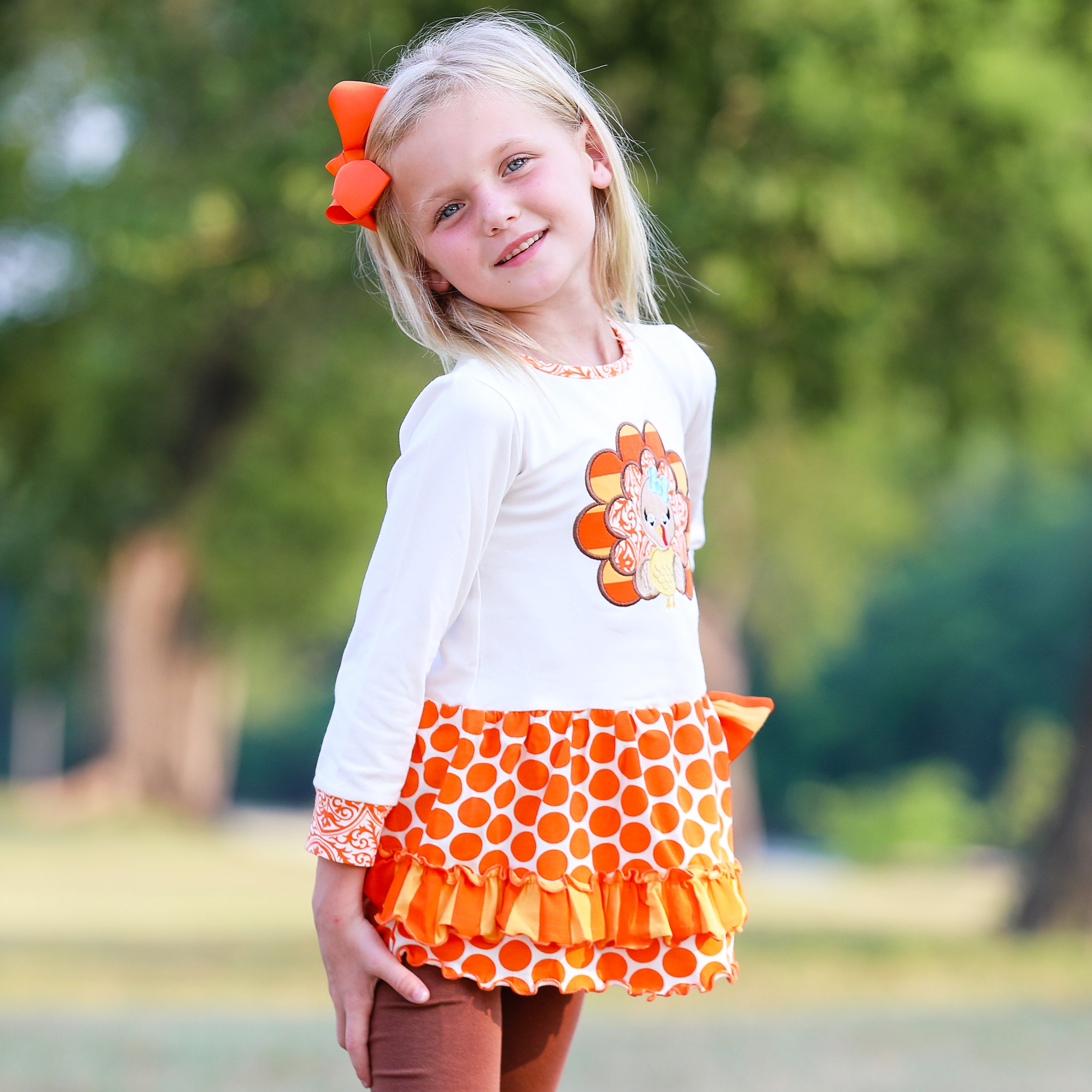 AnnLoren Big Little Girls Autumn Turkey Tunic & Leggings featuring a turkey applique, cream tunic, and orange knit leggings.